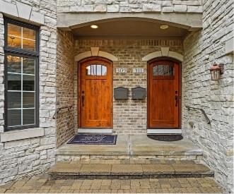 two wooden doors with two mailboxes