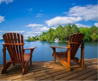 two wooden chairs on a dock